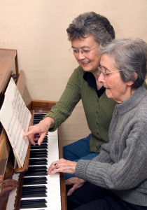 Senior adult learning to play the piano