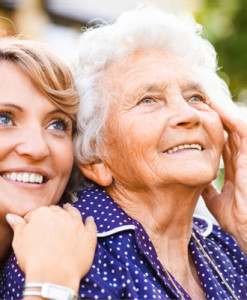 mom and daughter looking towards sky smiling