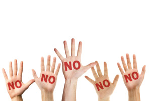 The word "NO" written on several palms.