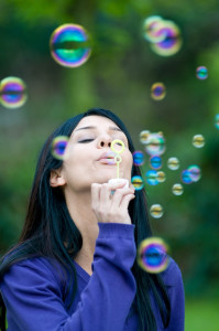 girl blowing bubbles