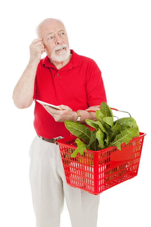 Senior man shopping for groceries looking forgetful