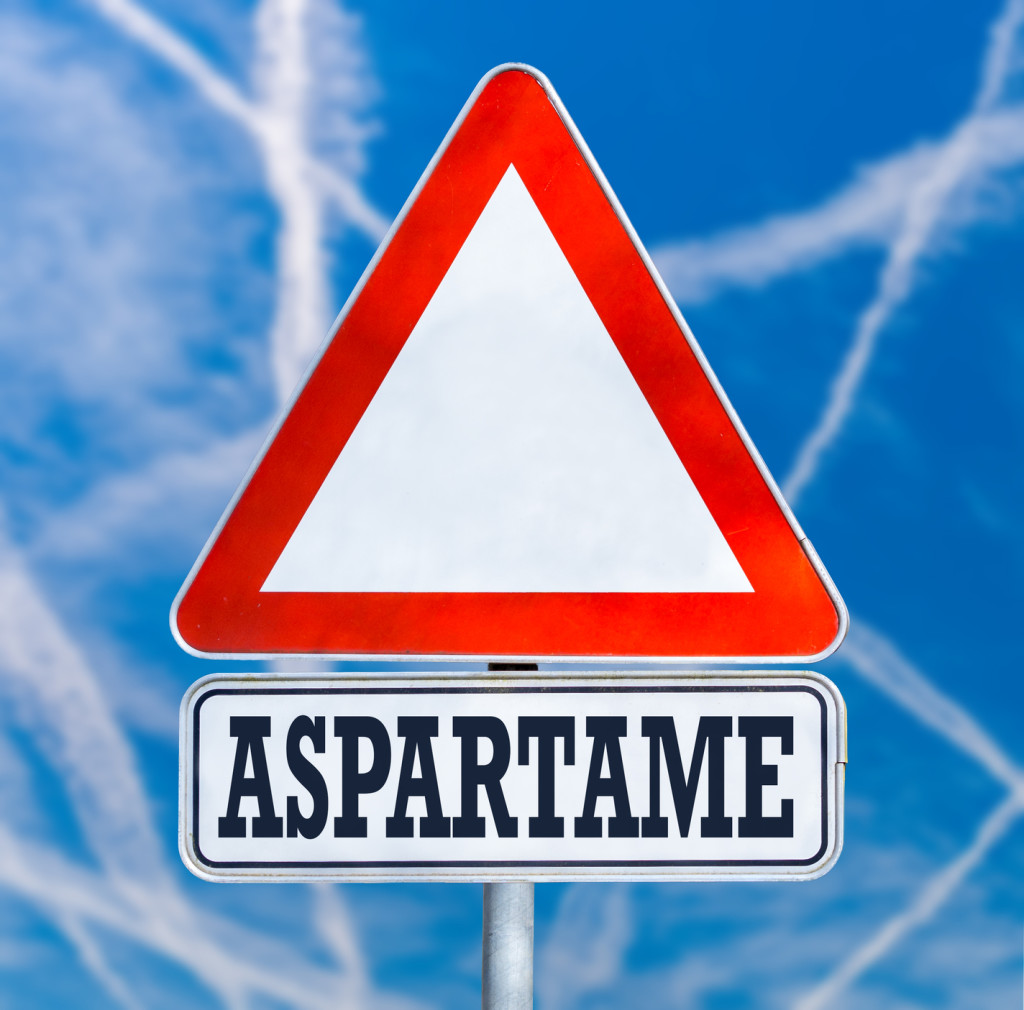 Conceptual image of a triangular white traffic warning sign with the word - Aspartame 