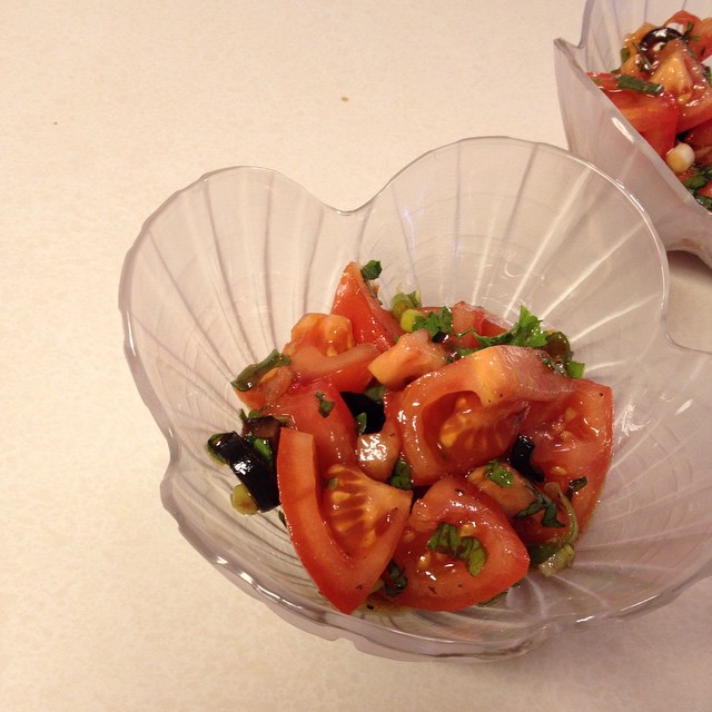 marinated tomato salad in a scalloped bowl