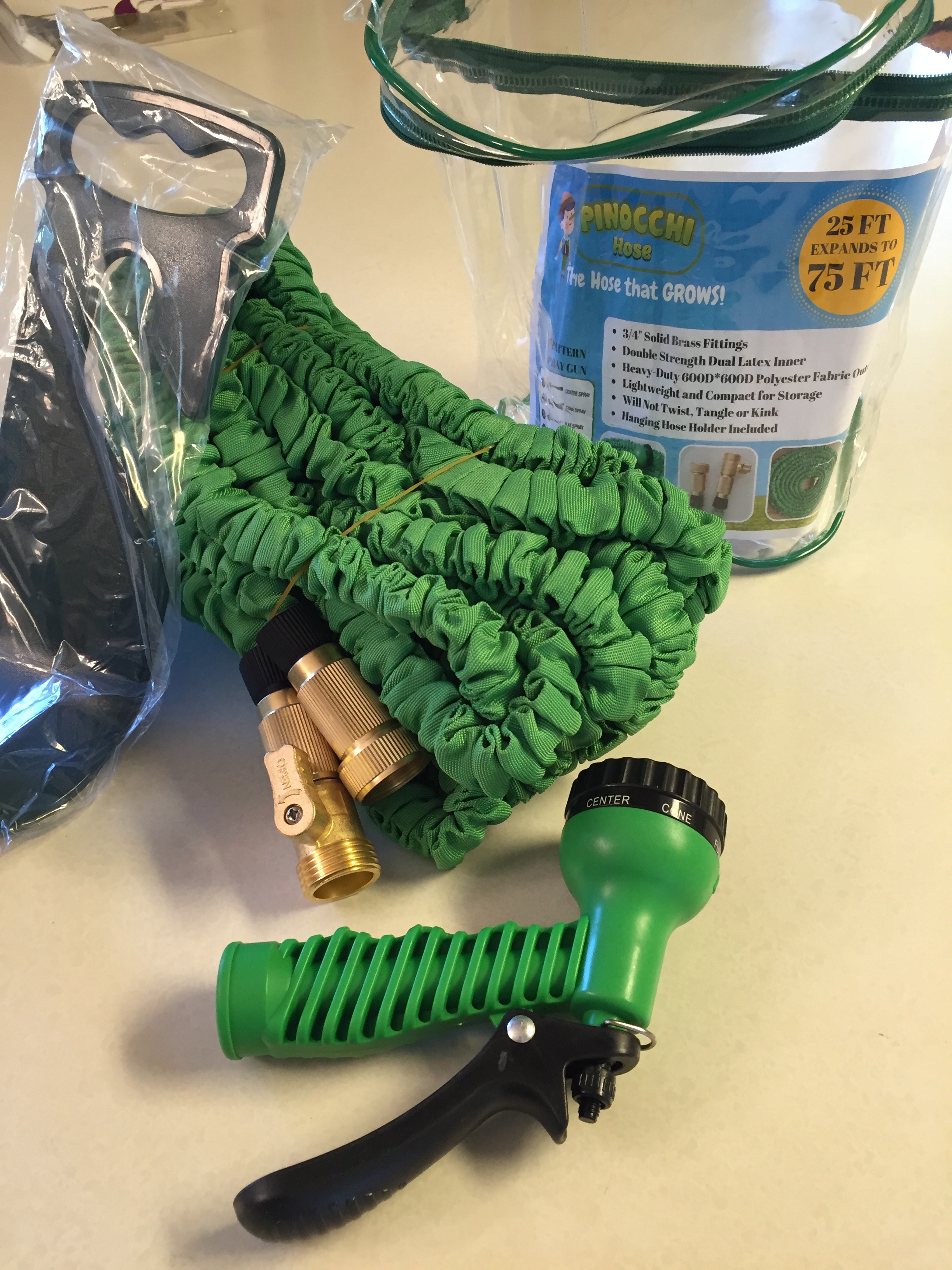 packaged green hose and hose holder