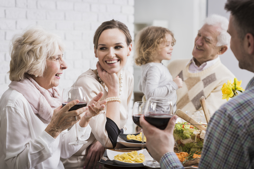 Happy multi-generational family gathering during holidays at the table