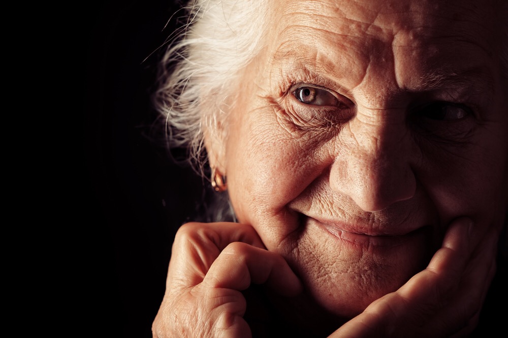 a smiling senior woman on dark background