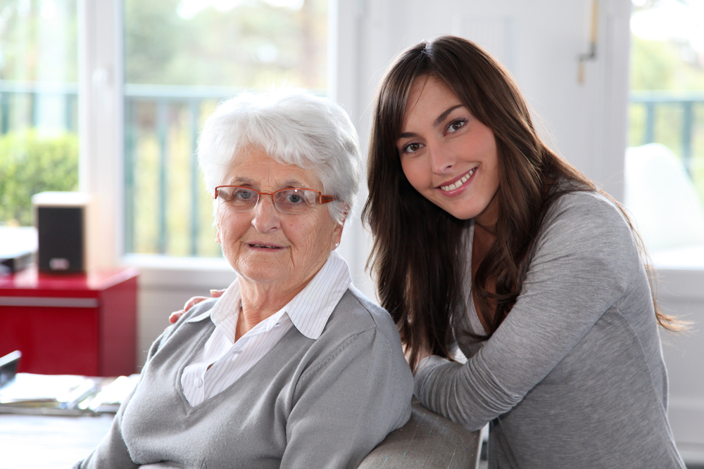 Closeup of elderly woman with female geriatric care manager