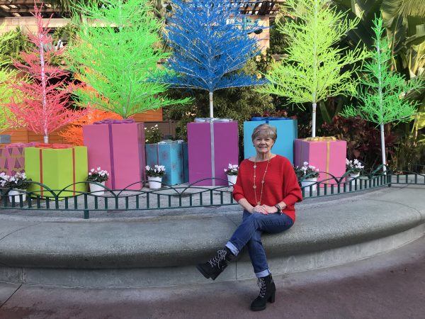 Shelley sitting in front of a neon tree display