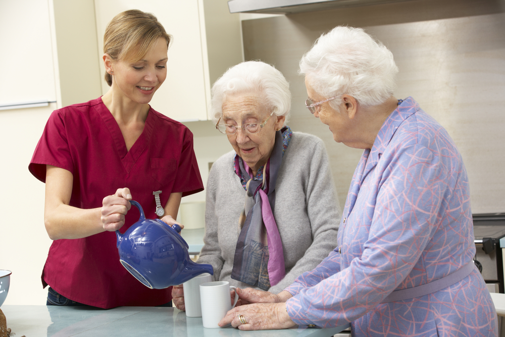 Senior women in an assisted living home with carer