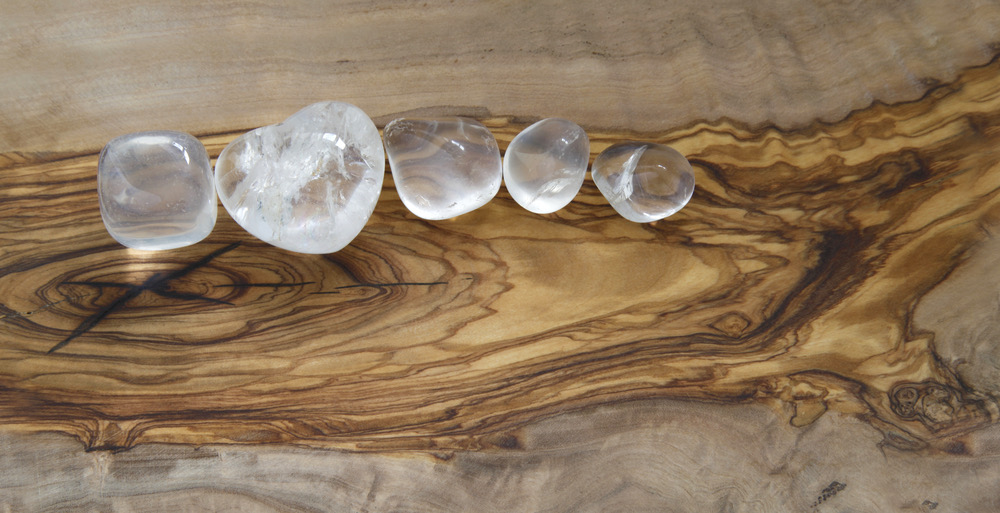 5 pieces of clear quartz on a brown tray