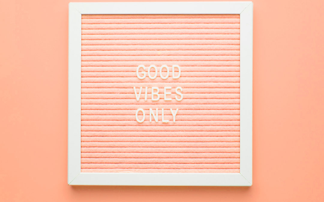 peach colored letter board that says Good Vibes Only