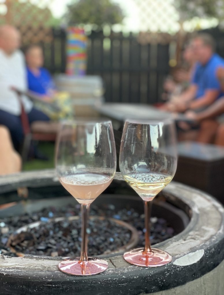 2 wine beverages sitting on a ledge with a Jenga game in the background