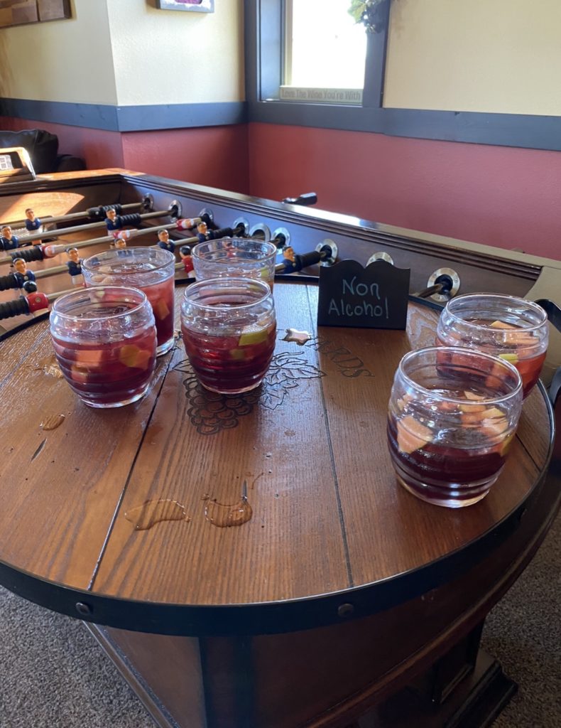 Glasses of red sangria on an oak serving platter.