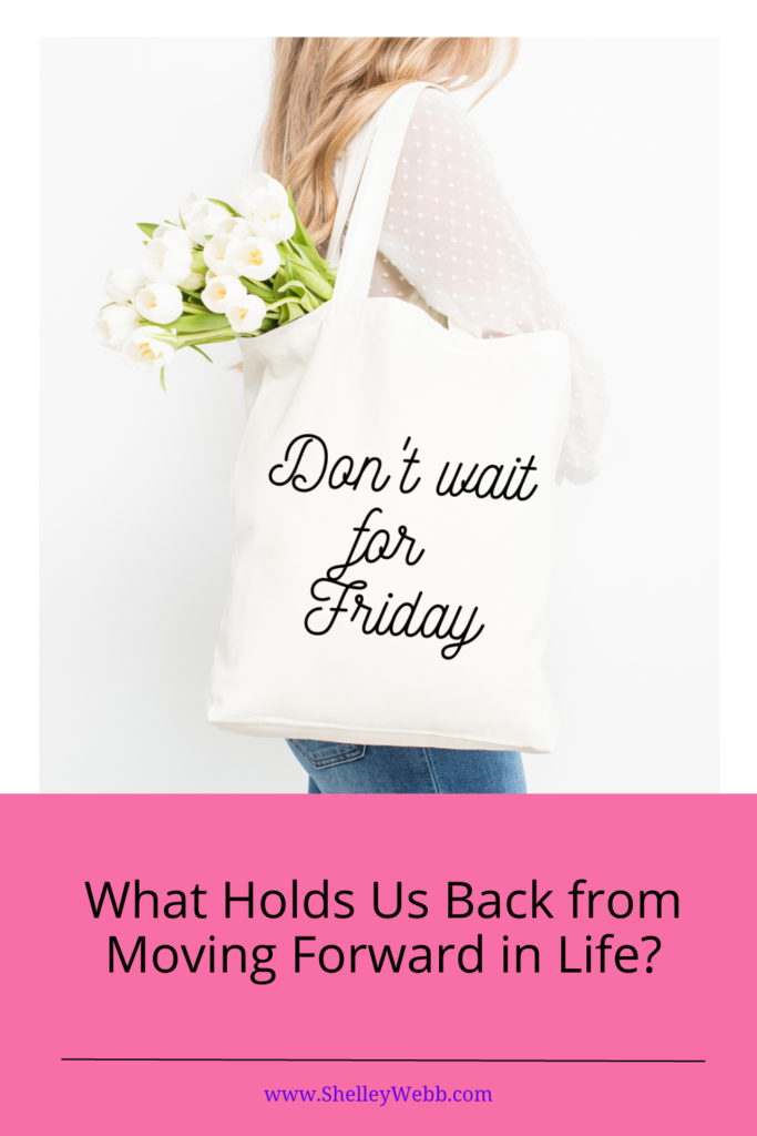 woman carrying a cotton grocery bg with white flowers in it. The bag says "don't wait for Friday".