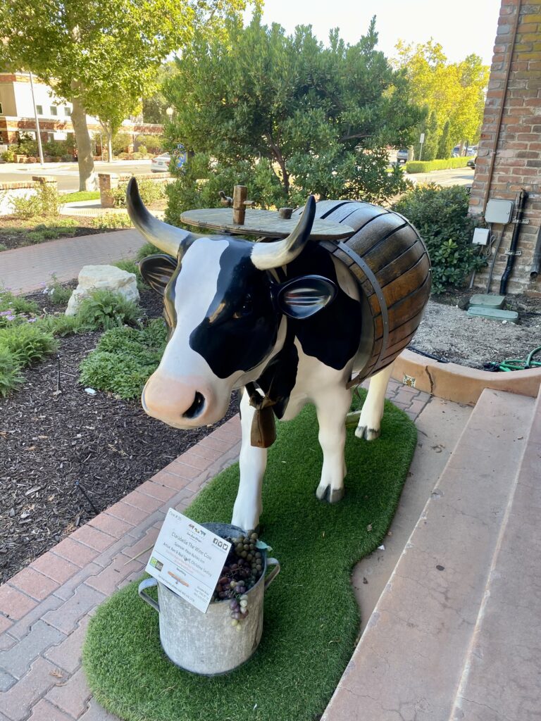 a black and white cow at the entrance to the Paso Robles Inn hotel lobby