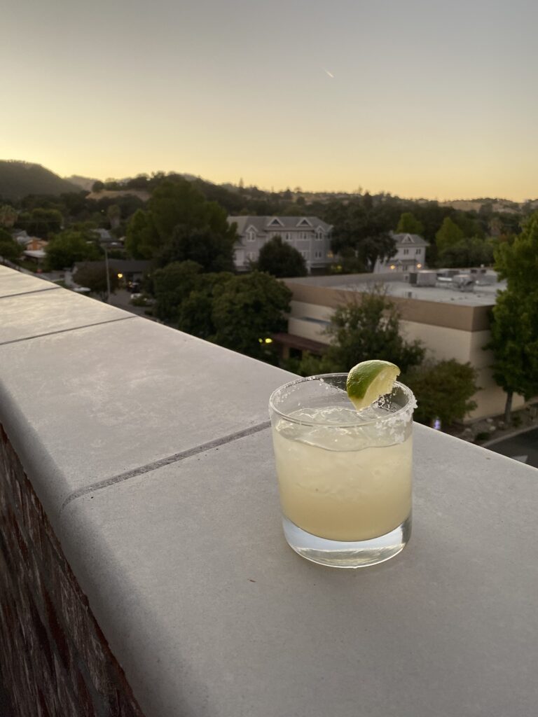a margarita on the wall overlooking the city