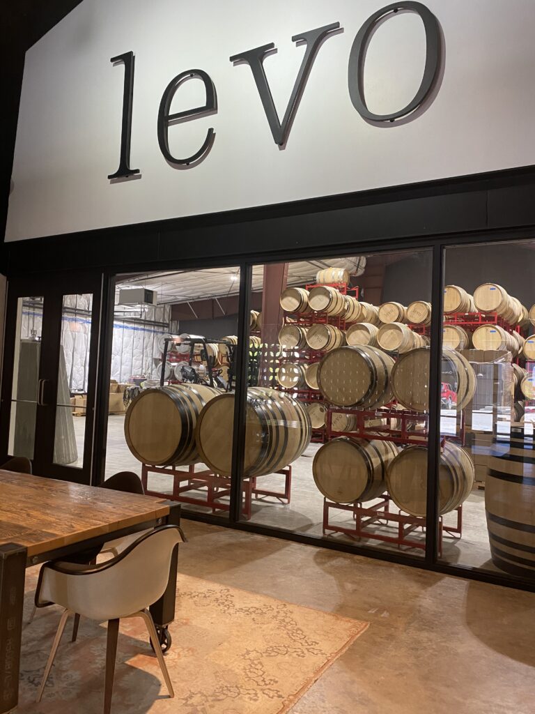 Inside the Levo tasting room, you can see some of the barrels through the glass
