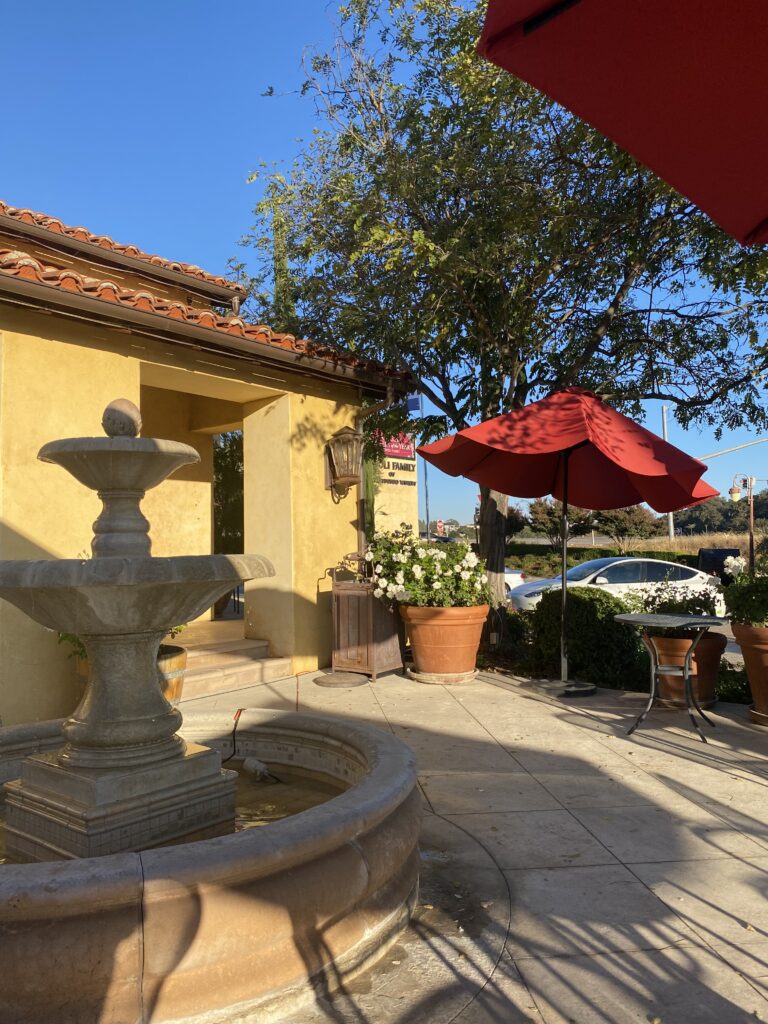 The courtyard of San Antonio Winery. There is a red umbrella in the distance.