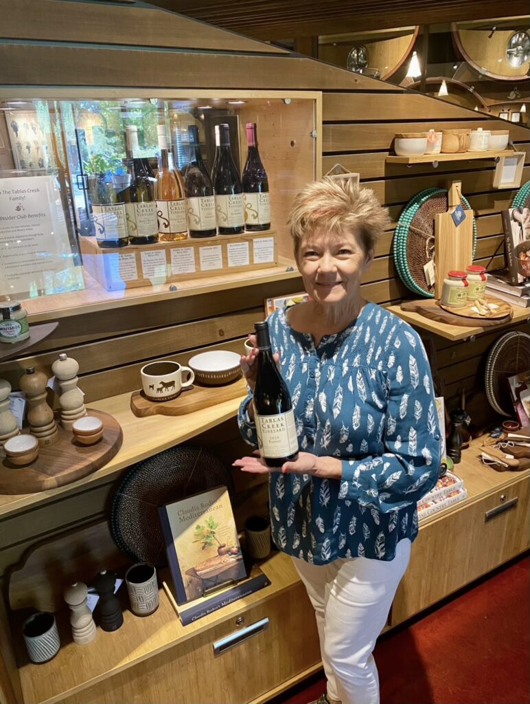 Shelley in the Tablas Creek giftshop holding a bottle of tanat.