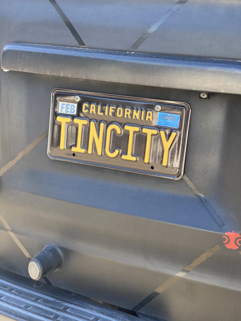 A California license plate that says Tin City