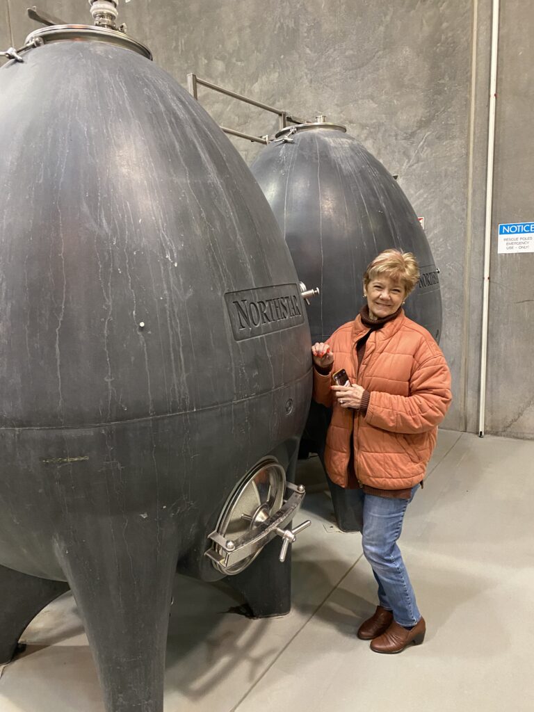 Shelley is standing by one of the concrete eggs